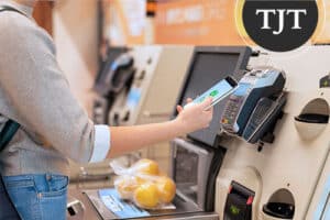 Woman checking her phone with shopping bags after a self-checkout shoplifting accusation in NJ